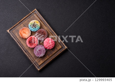 Chinese mooncake is an Asian sweet dessert. Asian mooncake as a background for your design 129993405