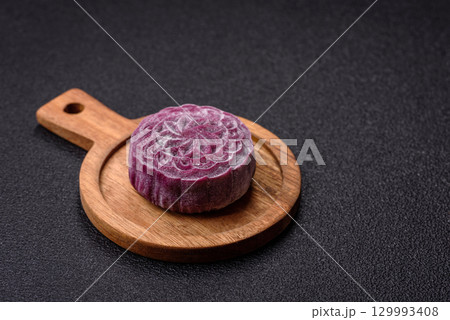 Chinese mooncake is an Asian sweet dessert. Asian mooncake as a background for your design Chinese mooncake is an Asian sweet dessert. Asian mooncake as a background for your design 129993408