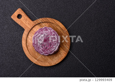 Chinese mooncake is an Asian sweet dessert. Asian mooncake as a background for your design 129993409