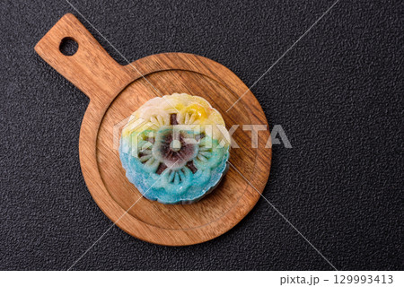 Chinese mooncake is an Asian sweet dessert. Asian mooncake as a background for your design Chinese mooncake is an Asian sweet dessert. Asian mooncake as a background for your design 129993413