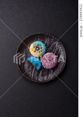 Chinese mooncake is an Asian sweet dessert. Asian mooncake as a background for your design Chinese mooncake is an Asian sweet dessert. Asian mooncake as a background for your design 129993421