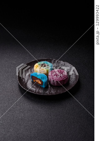 Chinese mooncake is an Asian sweet dessert. Asian mooncake as a background for your design Chinese mooncake is an Asian sweet dessert. Asian mooncake as a background for your design 129993422