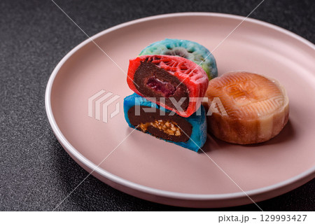 Chinese mooncake is an Asian sweet dessert. Asian mooncake as a background for your design Chinese mooncake is an Asian sweet dessert. Asian mooncake as a background for your design 129993427