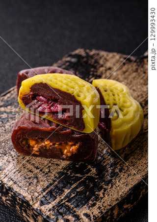 Chinese mooncake is an Asian sweet dessert. Asian mooncake as a background for your design Chinese mooncake is an Asian sweet dessert. Asian mooncake as a background for your design 129993430