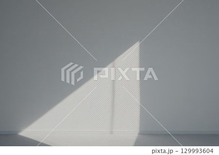 Geometric shadow play on minimalist white wall from blinds abstract architectural composition Geometric shadow play on minimalist white wall from blinds abstract architectural composition 129993604