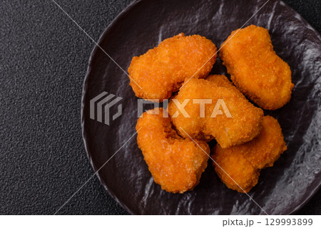 Chicken nuggets in breading, takeaway food, junk food Chicken nuggets in breading, takeaway food, junk food 129993899
