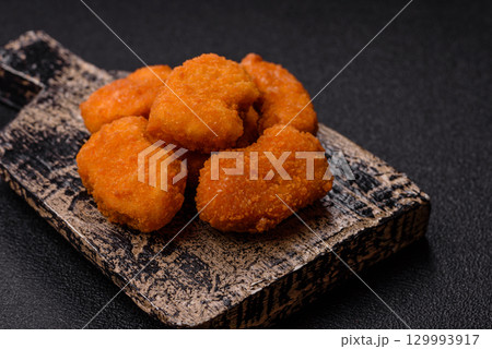 Chicken nuggets in breading, takeaway food, junk food Chicken nuggets in breading, takeaway food, junk food 129993917
