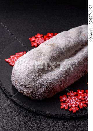 Christmas Stollen, a German sweet cake with marzipan and fruit. Winter Christmas Stollen 129994104