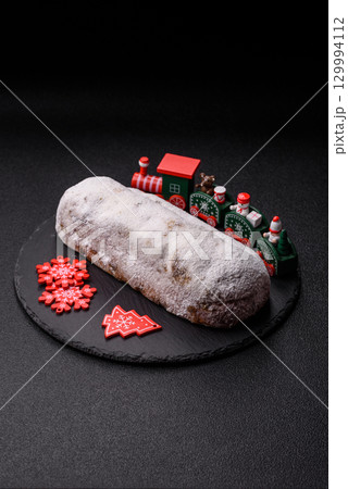 Christmas Stollen, a German sweet cake with marzipan and fruit. Winter Christmas Stollen 129994112