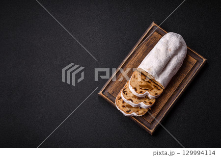 Christmas Stollen, a German sweet cake with marzipan and fruit. Winter Christmas Stollen 129994114