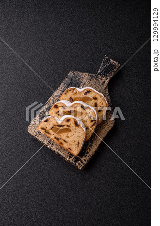 Christmas Stollen, a German sweet cake with marzipan and fruit. Winter Christmas Stollen Christmas Stollen, a German sweet cake with marzipan and fruit. Winter Christmas Stollen 129994129