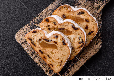 Christmas Stollen, a German sweet cake with marzipan and fruit. Winter Christmas Stollen 129994132