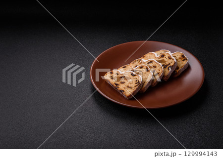 Christmas Stollen, a German sweet cake with marzipan and fruit. Winter Christmas Stollen Christmas Stollen, a German sweet cake with marzipan and fruit. Winter Christmas Stollen 129994143