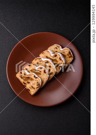Christmas Stollen, a German sweet cake with marzipan and fruit. Winter Christmas Stollen 129994145