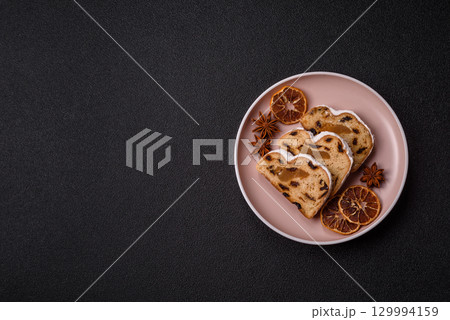 Christmas Stollen, a German sweet cake with marzipan and fruit. Winter Christmas Stollen Christmas Stollen, a German sweet cake with marzipan and fruit. Winter Christmas Stollen 129994159