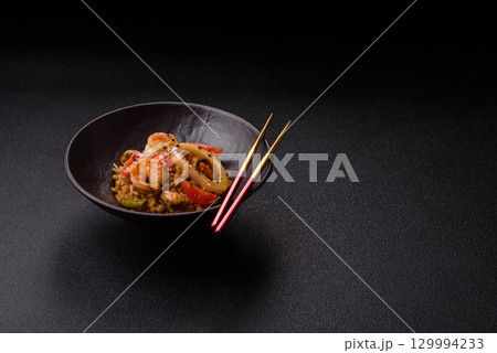 Rice and prawns or paella, a meal with seafood and vegetables. Cooked rice with shrimp Rice and prawns or paella, a meal with seafood and vegetables. Cooked rice with shrimp 129994233