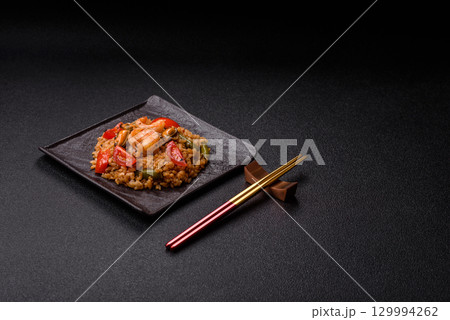 Rice and prawns or paella, a meal with seafood and vegetables. Cooked rice with shrimp Rice and prawns or paella, a meal with seafood and vegetables. Cooked rice with shrimp 129994262