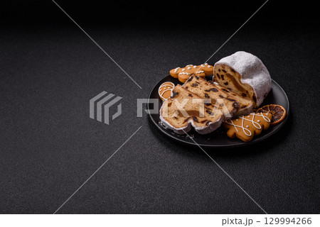 Christmas Stollen, a German sweet cake with marzipan and fruit. Winter Christmas Stollen Christmas Stollen, a German sweet cake with marzipan and fruit. Winter Christmas Stollen 129994266
