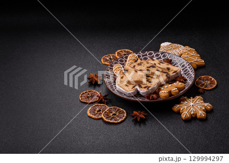 Christmas Stollen, a German sweet cake with marzipan and fruit. Winter Christmas Stollen Christmas Stollen, a German sweet cake with marzipan and fruit. Winter Christmas Stollen 129994297