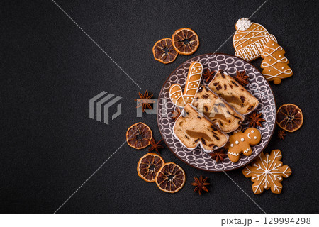Christmas Stollen, a German sweet cake with marzipan and fruit. Winter Christmas Stollen Christmas Stollen, a German sweet cake with marzipan and fruit. Winter Christmas Stollen 129994298