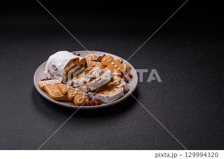 Christmas Stollen, a German sweet cake with marzipan and fruit. Winter Christmas Stollen Christmas Stollen, a German sweet cake with marzipan and fruit. Winter Christmas Stollen 129994320