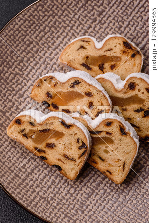 Christmas Stollen, a German sweet cake with marzipan and fruit. Winter Christmas Stollen Christmas Stollen, a German sweet cake with marzipan and fruit. Winter Christmas Stollen 129994365
