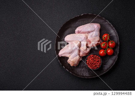 Raw chicken wings, fresh uncooked poultry meat. Chicken or turkey wings Raw chicken wings, fresh uncooked poultry meat. Chicken or turkey wings 129994488