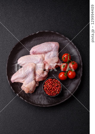 Raw chicken wings, fresh uncooked poultry meat. Chicken or turkey wings 129994489