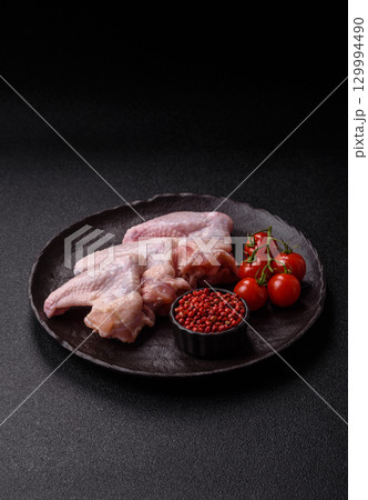 Raw chicken wings, fresh uncooked poultry meat. Chicken or turkey wings Raw chicken wings, fresh uncooked poultry meat. Chicken or turkey wings 129994490