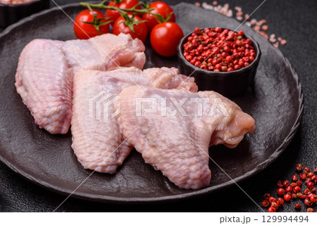 Raw chicken wings, fresh uncooked poultry meat. Chicken or turkey wings Raw chicken wings, fresh uncooked poultry meat. Chicken or turkey wings 129994494