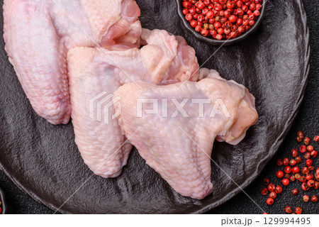 Raw chicken wings, fresh uncooked poultry meat. Chicken or turkey wings 129994495