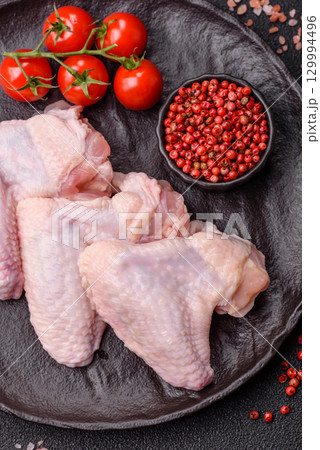 Raw chicken wings, fresh uncooked poultry meat. Chicken or turkey wings Raw chicken wings, fresh uncooked poultry meat. Chicken or turkey wings 129994496