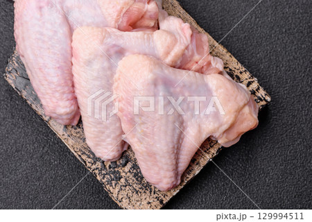 Raw chicken wings, fresh uncooked poultry meat. Chicken or turkey wings 129994511