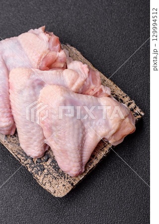 Raw chicken wings, fresh uncooked poultry meat. Chicken or turkey wings Raw chicken wings, fresh uncooked poultry meat. Chicken or turkey wings 129994512