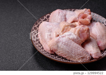 Raw chicken wings, fresh uncooked poultry meat. Chicken or turkey wings 129994522