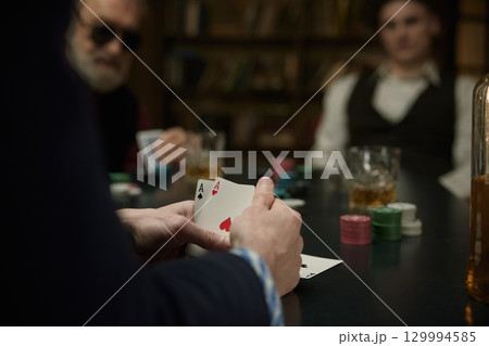 Serious determined man thinking about the course of the poker game in a vintage bar 129994585