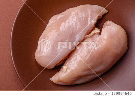 Meat, raw chicken fillets, poultry breast, skinless and boneless food. Raw chicken fillet 129994640
