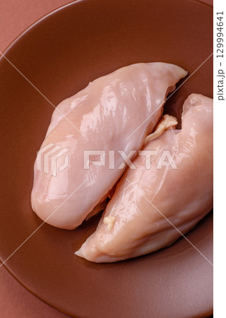 Meat, raw chicken fillets, poultry breast, skinless and boneless food. Raw chicken fillet 129994641