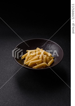 Penne pasta cooked with cheese, salt and spices. Italian food penne pasta 129995211
