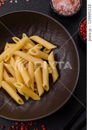 Penne pasta cooked with cheese, salt and spices. Italian food penne pasta 129995218