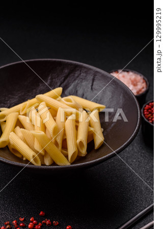 Penne pasta cooked with cheese, salt and spices. Italian food penne pasta 129995219