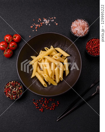 Penne pasta cooked with cheese, salt and spices. Italian food penne pasta 129995222