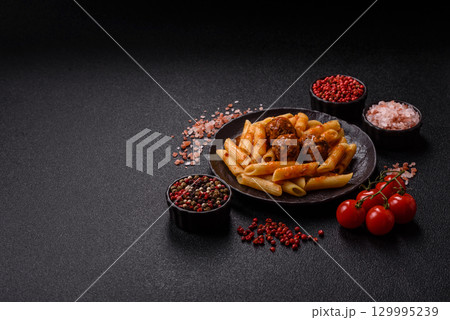 Penne pasta with meatballs in tomato sauce with salt and spices. Italian food penne pasta Penne pasta with meatballs in tomato sauce with salt and spices. Italian food penne pasta 129995239