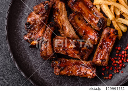 Meat, beef ribs in a marinade grilled with salt and spices. Grilled ribs 129995381