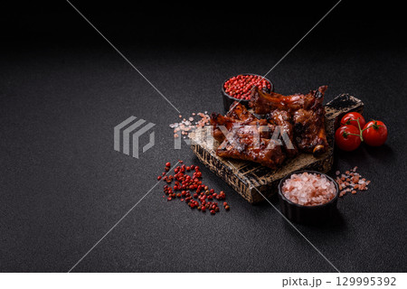 Meat, beef ribs in a marinade grilled with salt and spices. Grilled ribs Meat, beef ribs in a marinade grilled with salt and spices. Grilled ribs 129995392