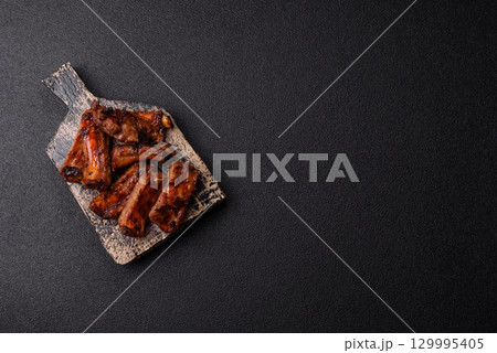 Meat, beef ribs in a marinade grilled with salt and spices. Grilled ribs Meat, beef ribs in a marinade grilled with salt and spices. Grilled ribs 129995405