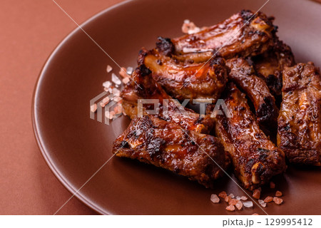 Meat, beef ribs in a marinade grilled with salt and spices. Grilled ribs 129995412