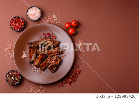 Meat, beef ribs in a marinade grilled with salt and spices. Grilled ribs Meat, beef ribs in a marinade grilled with salt and spices. Grilled ribs 129995420