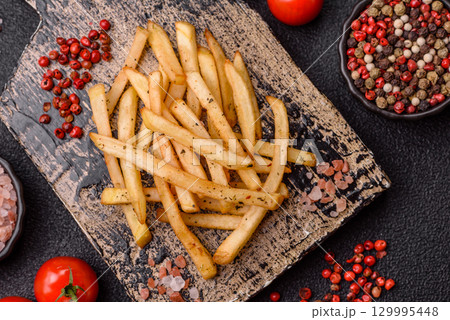 Food, French fries fried with salt and rosemary. Homemade crispy chips 129995448