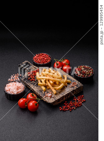 Food, French fries fried with salt and rosemary. Homemade crispy chips Food, French fries fried with salt and rosemary. Homemade crispy chips 129995454